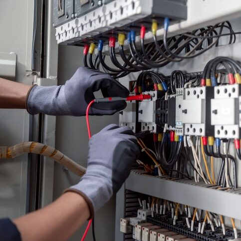 Electricity and electrical maintenance service,Electrical tests industrial electrical circuits with a multimeter in the control terminal box.