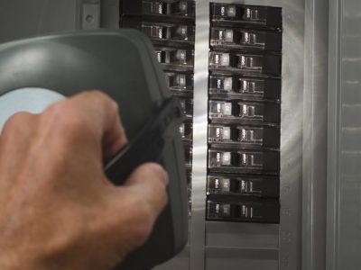 man with flashlight at residential service panel man with flashlight at residential service panel