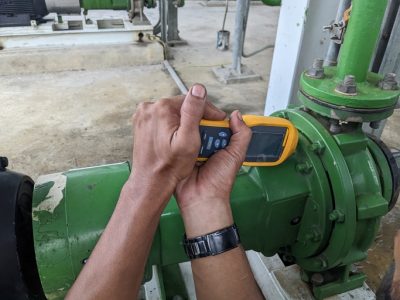 Man worker measure vibration motor and pump on power plant project.