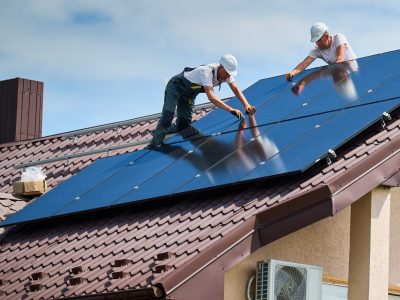 Worker building photovoltaic solar panel system on rooftop of house with help of hex key. Worker building photovoltaic solar panel system on rooftop of house with help of hex key.